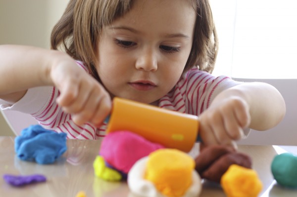Buying the right toys for babies, toddlers and preschoolers - girl_with_playdough-600x399