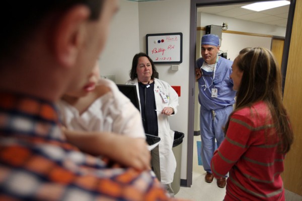 Nurse practitioner Michelle Wilson talks to the Pollocks before surgery
