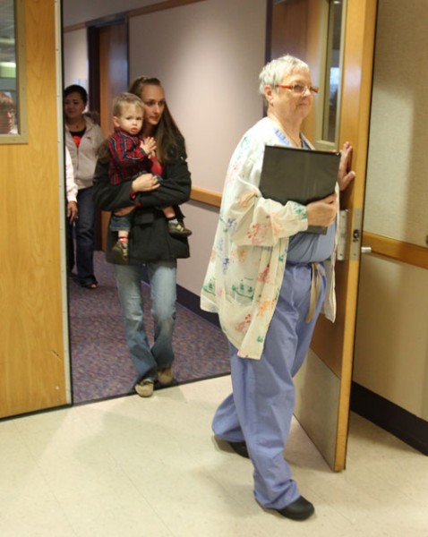 Lynda Stuber takes the Pollocks to an exam room for pre-surgery assessment.