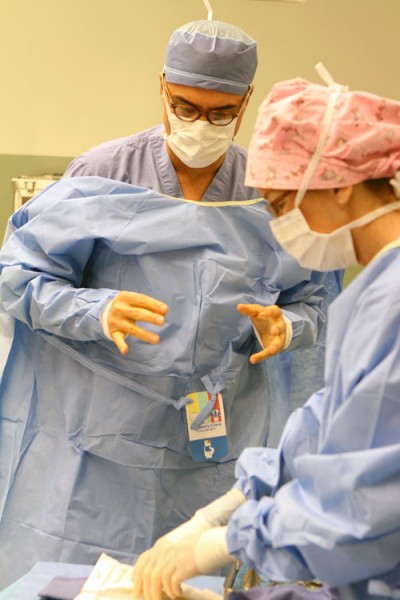Dr. Milo and OR nurse Marilyn Khoury scrubs into the OR
