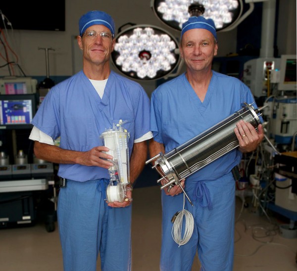 (L-R) Tom Murray holds the equipment that's currently used when patients are on the heart-lung bypass machine, while Mike Corrigan holds the equipment that was used in the 1970s.