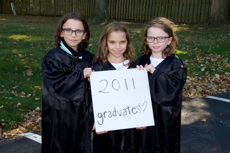 8 year old triplet girls in graduation gowns